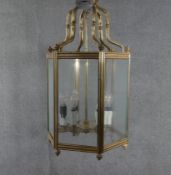 A large Victorian solid brass and glass hexagonal six branch lantern with ridged detailing and brass