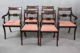 A set of six Regency style mahogany bar back dining chairs on reeded sabre supports, to include