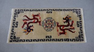 A Tibetan handmade dragon motif rug. 123x70cm