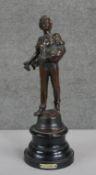 A bronze figure of a farm boy feeding chickens mounted on an ebonised base. Plaque reads Semeur. H.