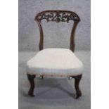 A 19th century carved mahogany bedroom chair on cabriole supports.