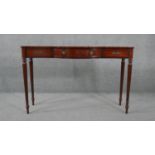 A mid century late Georgian style mahogany console table with satinwood stringing raised on tapering