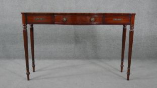 A mid century late Georgian style mahogany console table with satinwood stringing raised on tapering