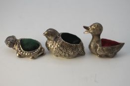 Three Danish silver animal novelty pin cushions. One as a partridge with green velvet cushion, one