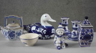 A collection of seven pieces of porcelain. Including a pair of blue willow pattern candlesticks,