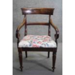 A Regency mahogany bar back armchair with scrolling arms on faceted tapering supports.
