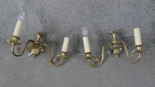 A pair of vintage brass acanthus and scrolling floral design two branch wall lights. H.30 W.34cm