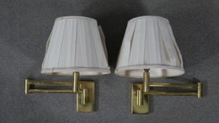 A pair of brass extending wall mounted lights with silk shades. H.37 W.60cm (extended)