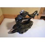 A large Art Deco bronzed female figure of flowing form. H.60 W.110 D.38cm