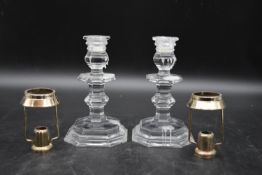 A pair of 20th century Baccarat cut crystal candle holders, along with a pair of silver plated