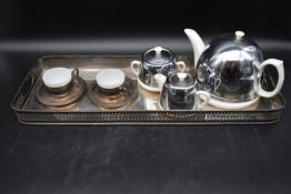 An Art Deco tea set for two with silver plated tray. To include a ceramic teapot, milk jug, sugar