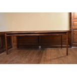 A 1960's vintage rosewood A. H. McIntosh extending dining table with extra leaf on shaped circular