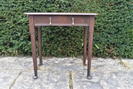 An 18th century country oak side table with rounded rectangular top and frieze drawer on pad foot