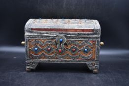 A Berber wooden jewellery box with silver gilt filigree inlay, turquoise and coral gems and metal