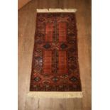 A rust ground Afghan style rug. H.180 W.86cm