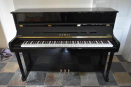 A 2012 Kawai upright piano, model K-2 in a lacquered ebonised case. H.114 W.147 D.56cm