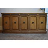 A walnut sideboard with panelled doors enclosing fitted interior on plinth base. H.76 W.170 D.48cm