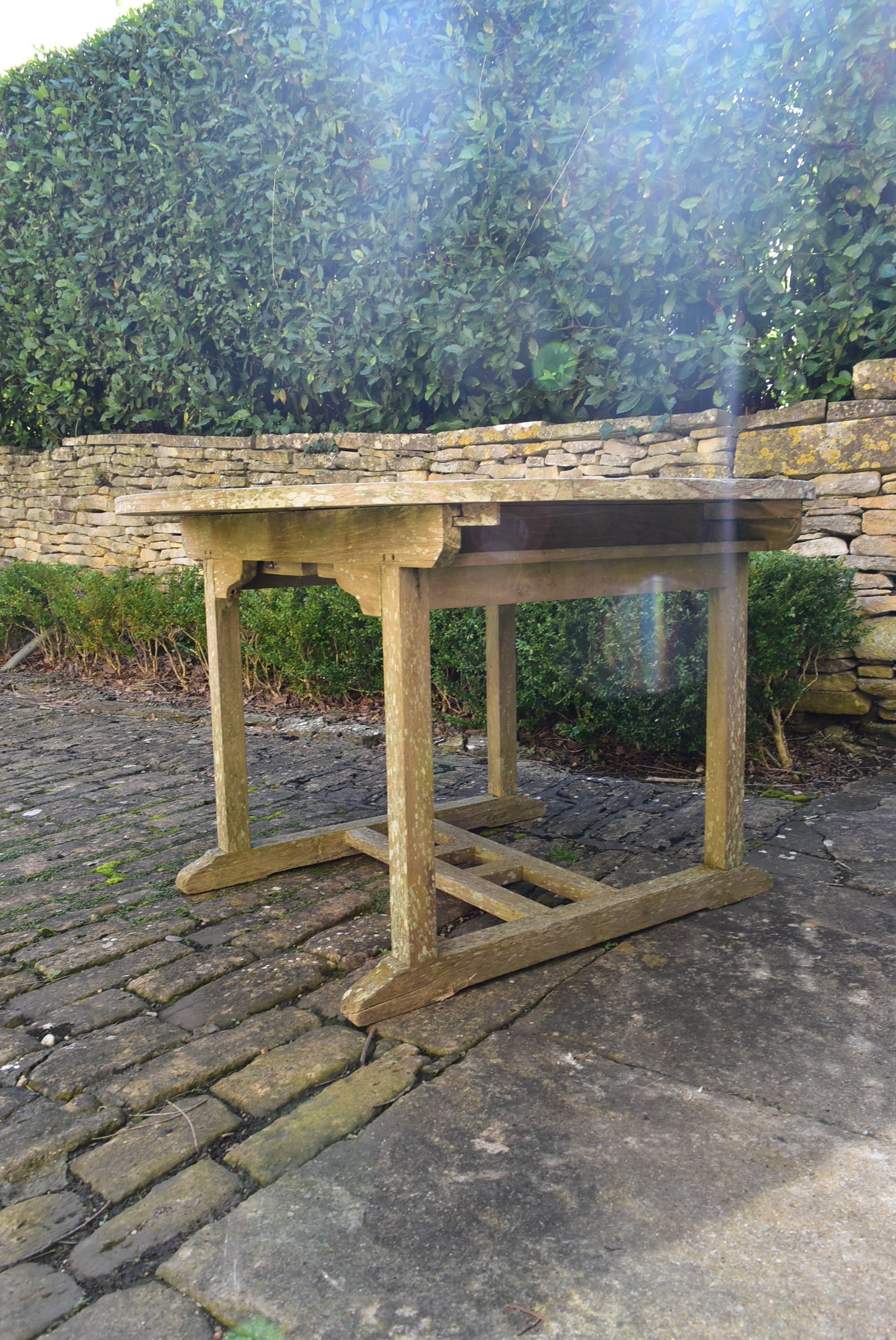 A weathered teak garden table with planked top on platform base. H.77 W.120 D.120cm - Image 3 of 6