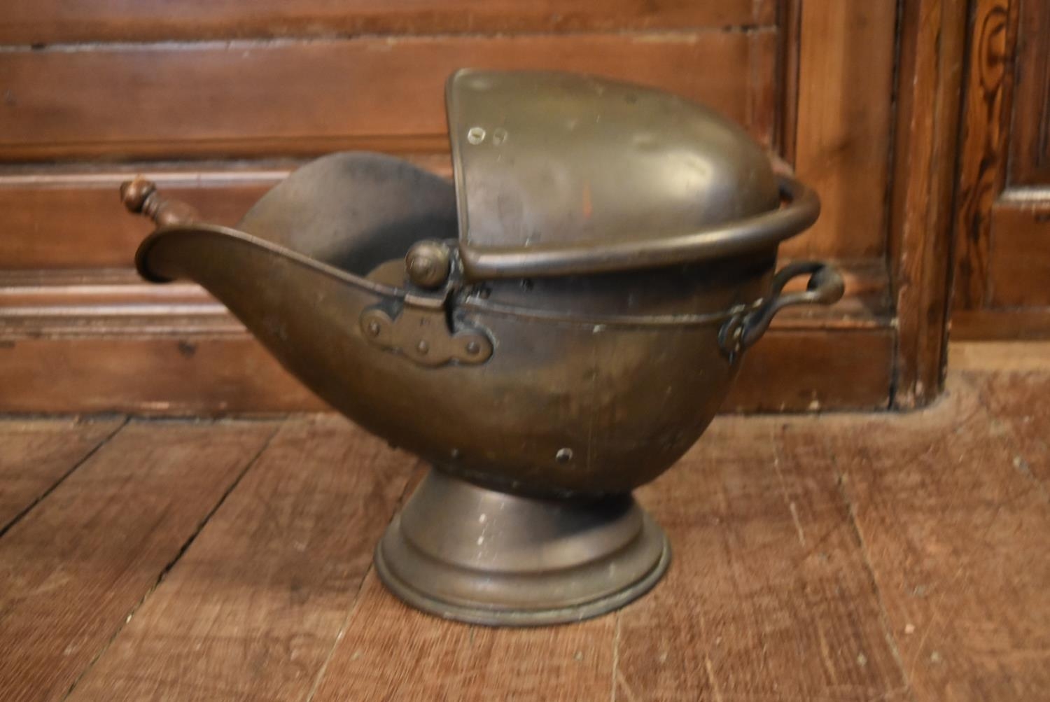 A Victorian helmet shaped brass coal scuttle with shovel. H.40 W.47cm (2)