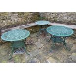 Three pierced wrought metal and painted garden tables. H.67 W.86cm (largest) (3)