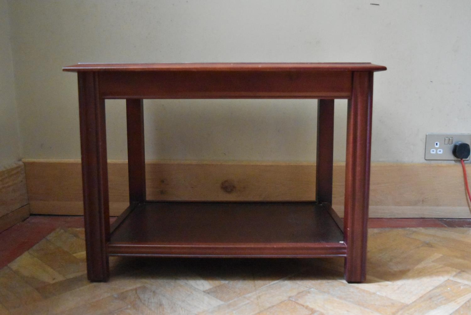 A mahogany coffee table with glass inset top on square supports. H.50 W.66 D.49cm