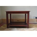 A mahogany coffee table with glass inset top on square supports. H.50 W.66 D.49cm