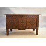 An 18th century country oak coffer with its original hinges and lozenge carved panels raised on