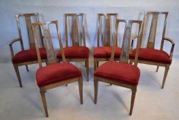 A set of six walnut dining chairs with caned back and upholstered seats on square tapering supports,