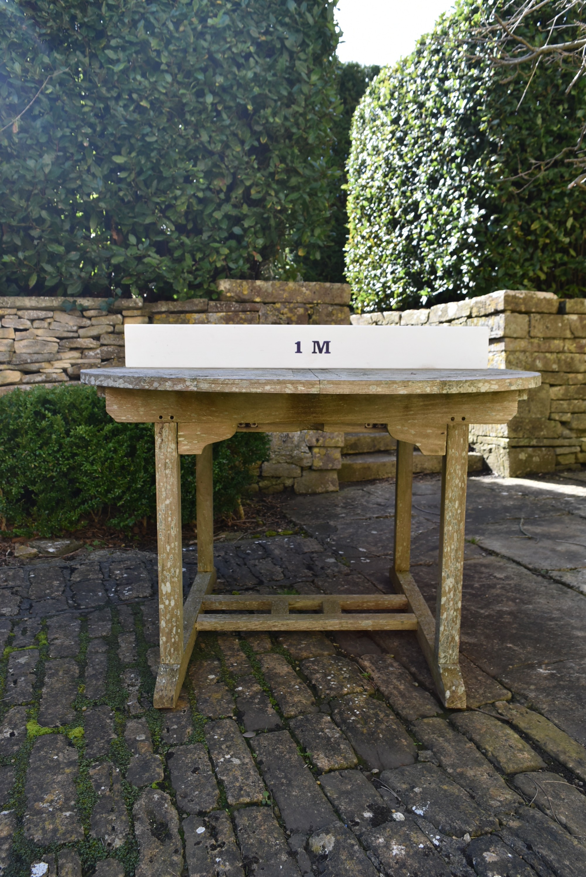 A weathered teak garden table with planked top on platform base. H.77 W.120 D.120cm - Image 6 of 6