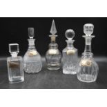 Five miscellaneous Victorian cut crystal glass decanters with silver drink labels. Hallmarked. H.