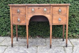 A Regency mahogany and crossbanded sideboard of compact size with lion mask handles raised on square