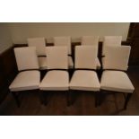 A set of eight dining chairs with upholstered seats and backs on shaped cabriole supports with loose