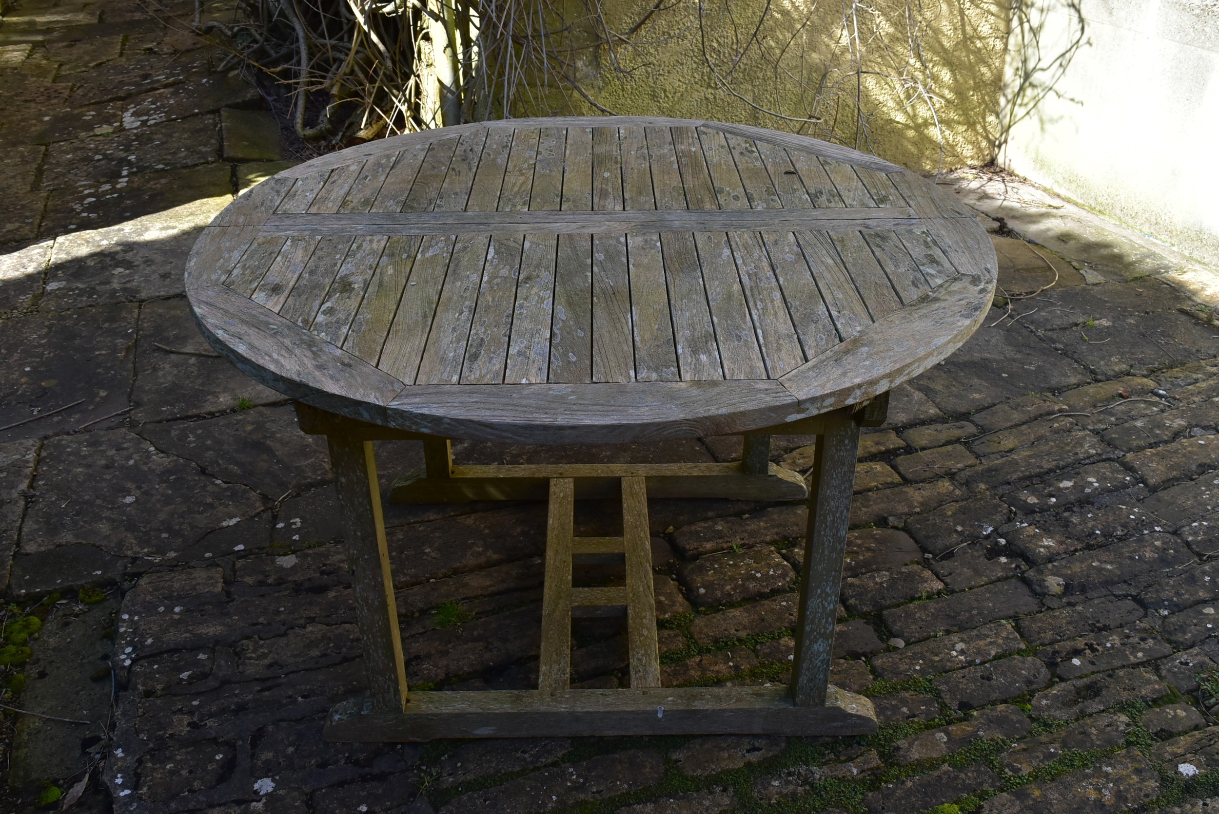 A weathered teak garden table with planked top on platform base. H.77 W.120 D.120cm - Image 5 of 6