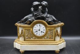 A 19th century French ormolu mantel clock, with a white enamal dial and Roman numerals, signed '