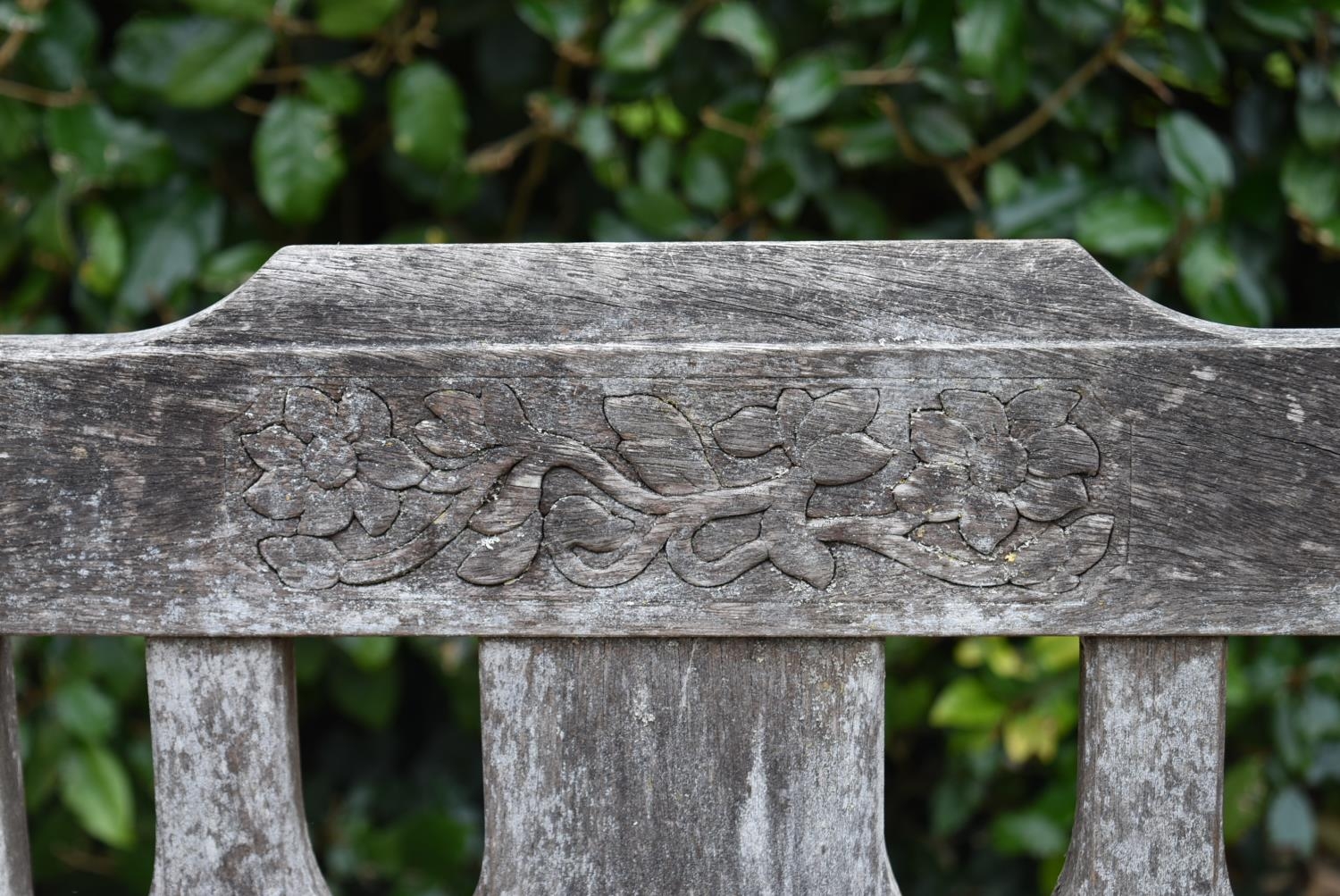 A set of four weathered teak garden chairs with carved back rails and slatted backs and seats on - Image 5 of 6