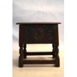 An 18th century country oak bible box stool with carved panel on turned tapering supports. H.47 W.44
