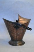 A late 19th century Arts and Crafts copper coal scuttle with a twisted wrought iron handle. H.45