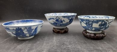 Three Qing dynasty Chinese blue and white porcelain footed bowls. Decorated with temples and figures