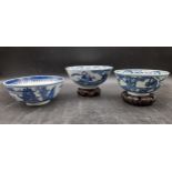 Three Qing dynasty Chinese blue and white porcelain footed bowls. Decorated with temples and figures