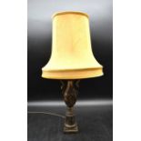 A brass baluster lamp with embossed Oriental male and female figural decoration and rope style