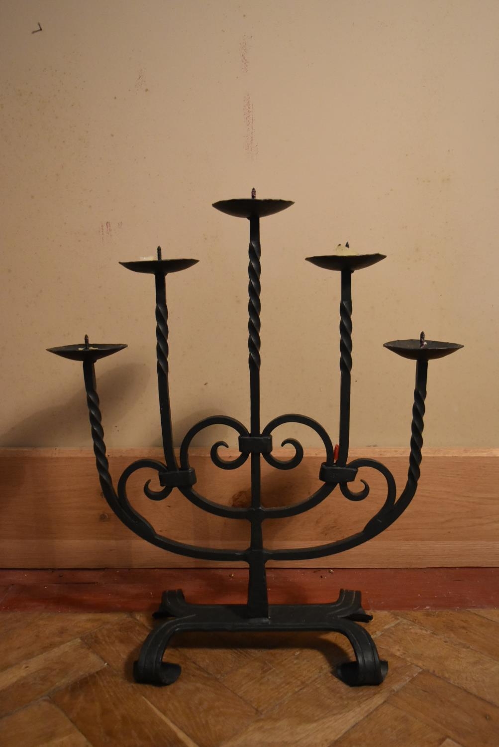 A 20th century five branch iron candelabra, stylised with twist branches and swirl design. H.54 W.