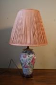 A 20th century Chinese style table lamp, decorated in floral design, along with a blush pleated