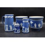 A collection of Wedgewood blue Jasperware to include two planters and three jugs with classical
