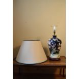 A contemporary baluster form table lamp with floral decoration and cream shade. H.60 W.22cm