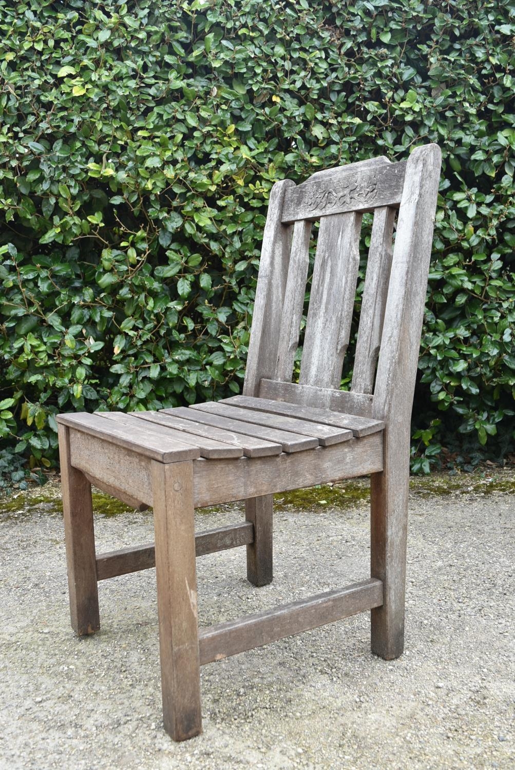 A set of four weathered teak garden chairs with carved back rails and slatted backs and seats on - Image 6 of 6