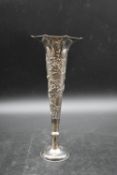 A early 20th century Woshing Chinese trumpet design silver spill vase decorated with relief chrysant