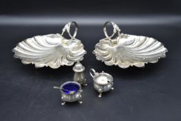 A collection of silver and silver plate. Including a pair of plated scallop shell shaped dishes, and