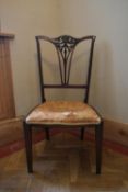 A late Victorian mahogany salon chair with floral carved splat back on square tapering supports. H.