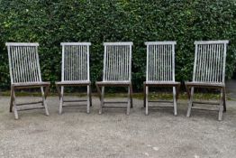 A set of five weathered teak folding and slatted garden chairs. H.99 W.46 D.43cm