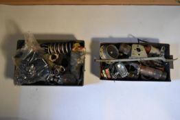 A collection of various car parts, including suspension springs, solenoid, a headlamp,